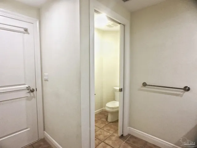 a bathroom with a granite countertop toilet and a sink