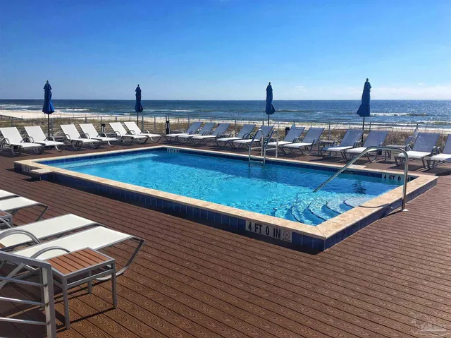 a view of a swimming pool with outdoor seating