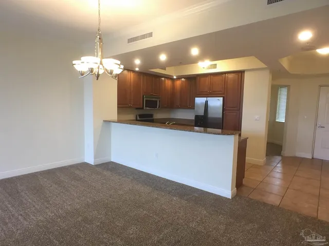 a view of a kitchen with a sink and chandelier