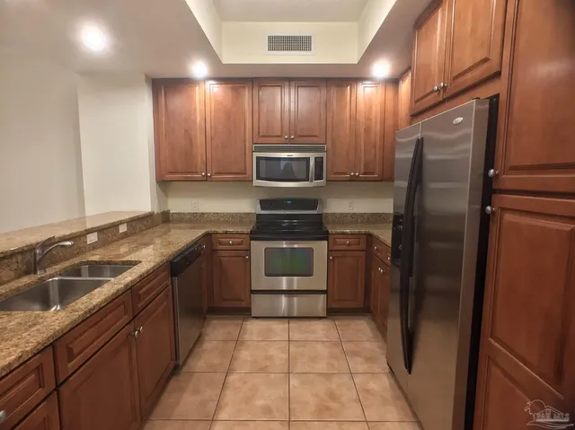 a kitchen with a refrigerator sink and stove