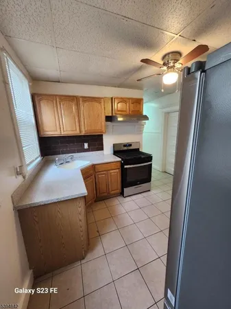 a kitchen with stainless steel appliances a stove a sink and a refrigerator