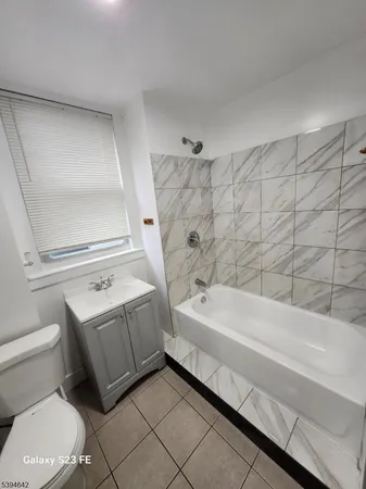 a bathroom with a sink a toilet and bathtub