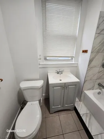 a bathroom with a sink toilet and tub