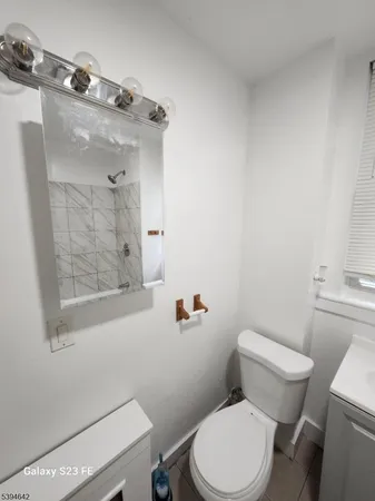 a white toilet sitting next to a bathroom sink
