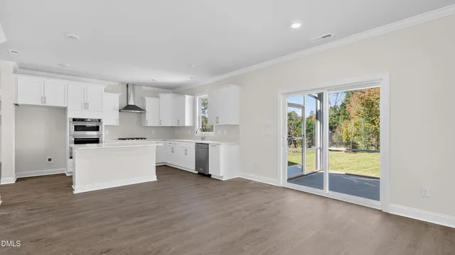 a kitchen with kitchen island granite countertop white cabinets and white appliances