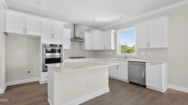 a kitchen with cabinets appliances a sink and a window