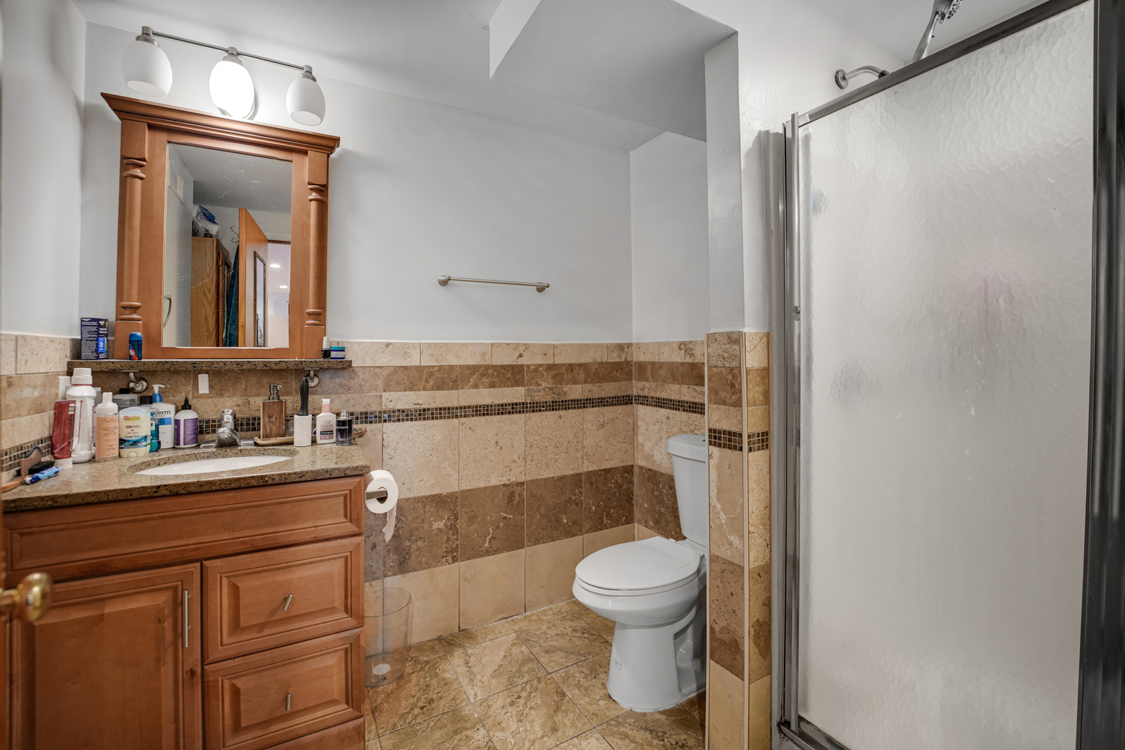 8845 West 75th Street Justice, IL 60458 - Photo 4 of 14 a bathroom with a toilet sink and shower