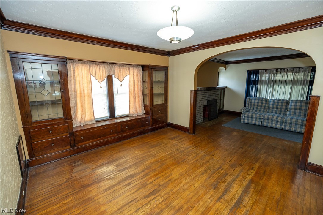 10105 Unity Avenue Cleveland, OH 44111 - Photo 17 of 35 Hardwood floored spare room featuring crown molding and a fireplace