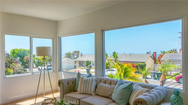 a living room with furniture and kitchen view