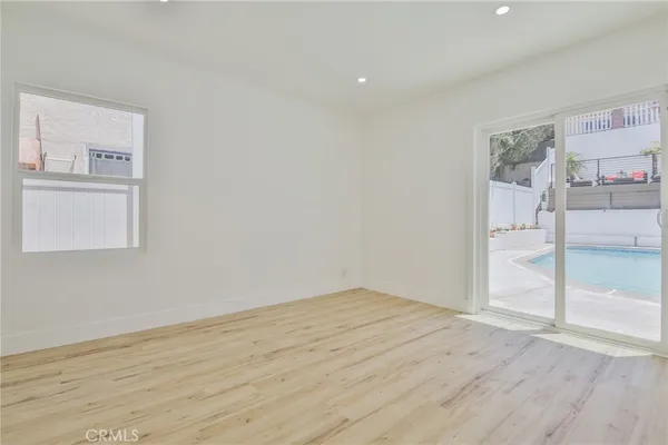 a view of empty room with wooden floor