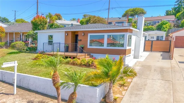 an aerial view of a house with pool and furniture