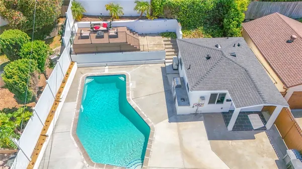 a view of a house with backyard and sitting area