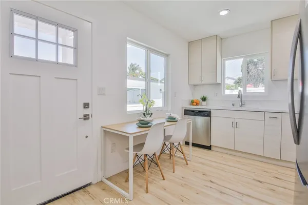 a kitchen with stainless steel appliances granite countertop a stove a refrigerator and a microwave