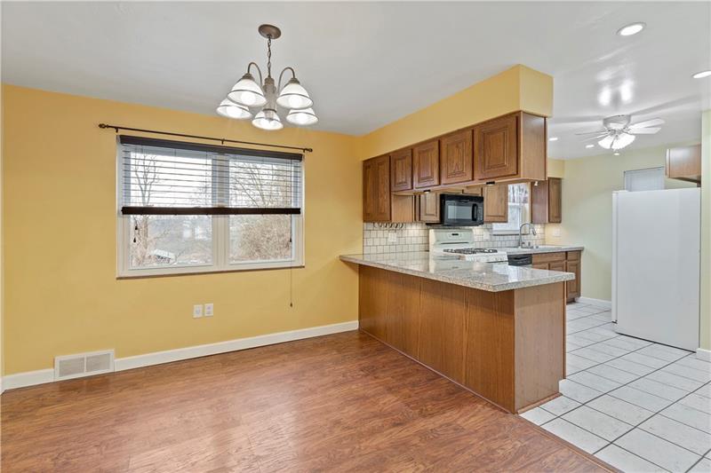 396 Hoffman Road Pittsburgh, PA 15212 - Photo 8 of 24 You can keep your guests company while cooking in the open concept kitchen dining room area! Plenty of storage with all of the wood cabinets!
