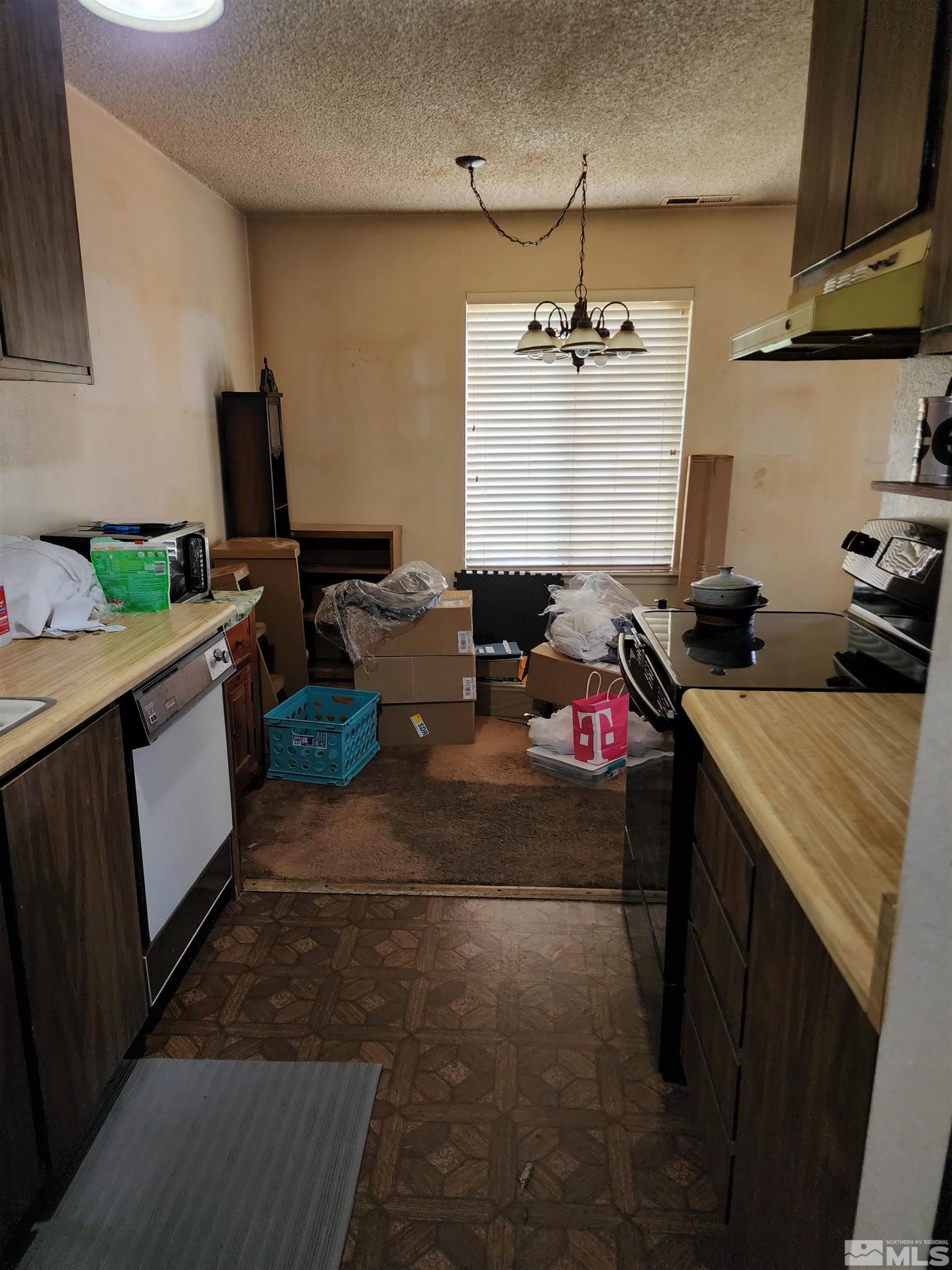 4600 Neil Road, Unit 9 Reno, NV 89502 - Photo 14 of 21 a kitchen with a sink stove and cabinets