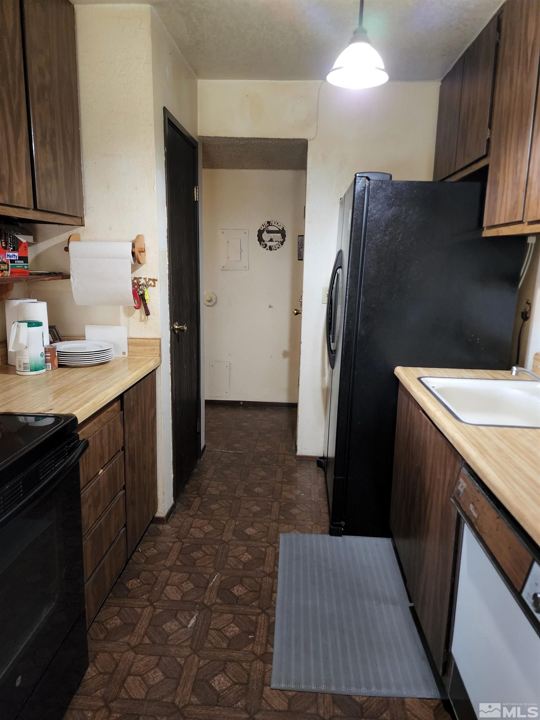 4600 Neil Road, Unit 9 Reno, NV 89502 - Photo 15 of 21 a kitchen with refrigerator and cabinets