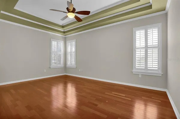 a view of an empty room with wooden floor