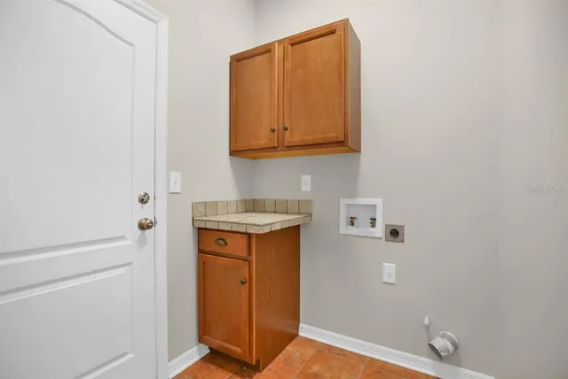 a view of a patio with couches table and chairs under an umbrella