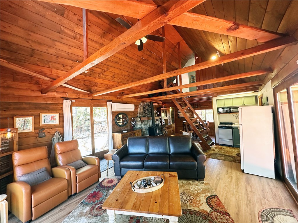 24387 Rocky Point Road Idyllwild, CA 92549 - Photo 15 of 29 a living room with a couch and a table