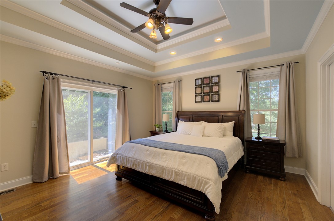 100 Turnberry Road Anderson, SC 29621 - Photo 15 of 41 Hardwood floors and a tray ceiling with a fan enhance this serene primary bedroom retreat.