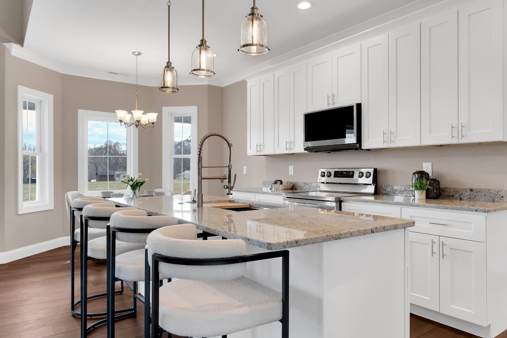 249 Lookout Drive Winchester, TN 37398 - Photo 16 of 63 a kitchen with stainless steel appliances kitchen island granite countertop a stove a sink a dining table and chairs with wooden floor
