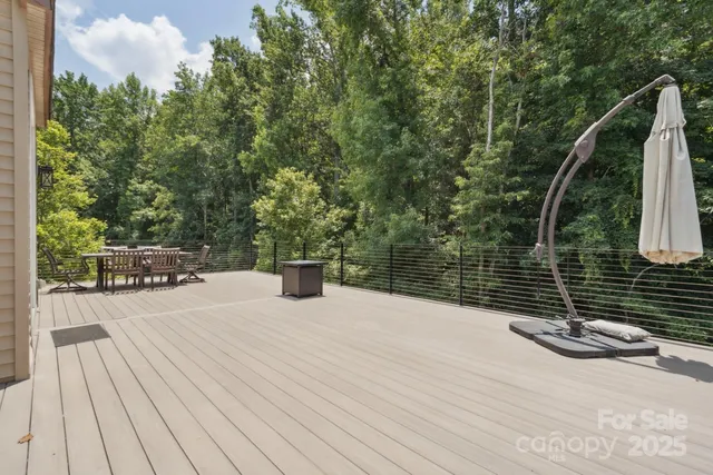 a view of roof deck with a barbeque and wooden stairs