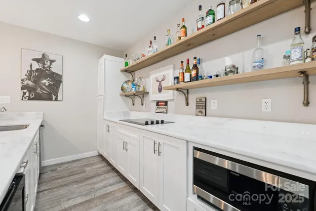 a kitchen with granite countertop white cabinets and white appliances