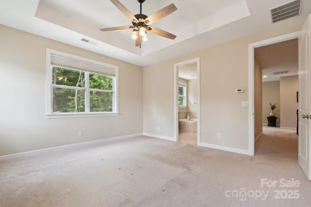 a spacious bathroom with a tub sink and mirror