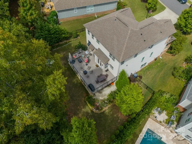 an aerial view of a house with a yard