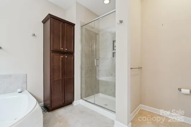 a bathroom with a tub a sink and mirror