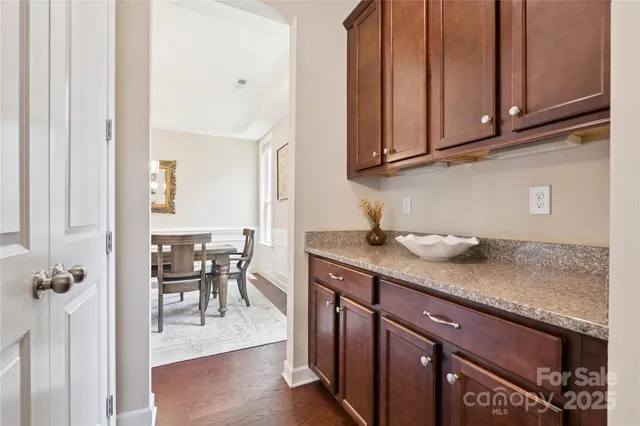 a kitchen with stainless steel appliances granite countertop wooden cabinets a sink and dishwasher