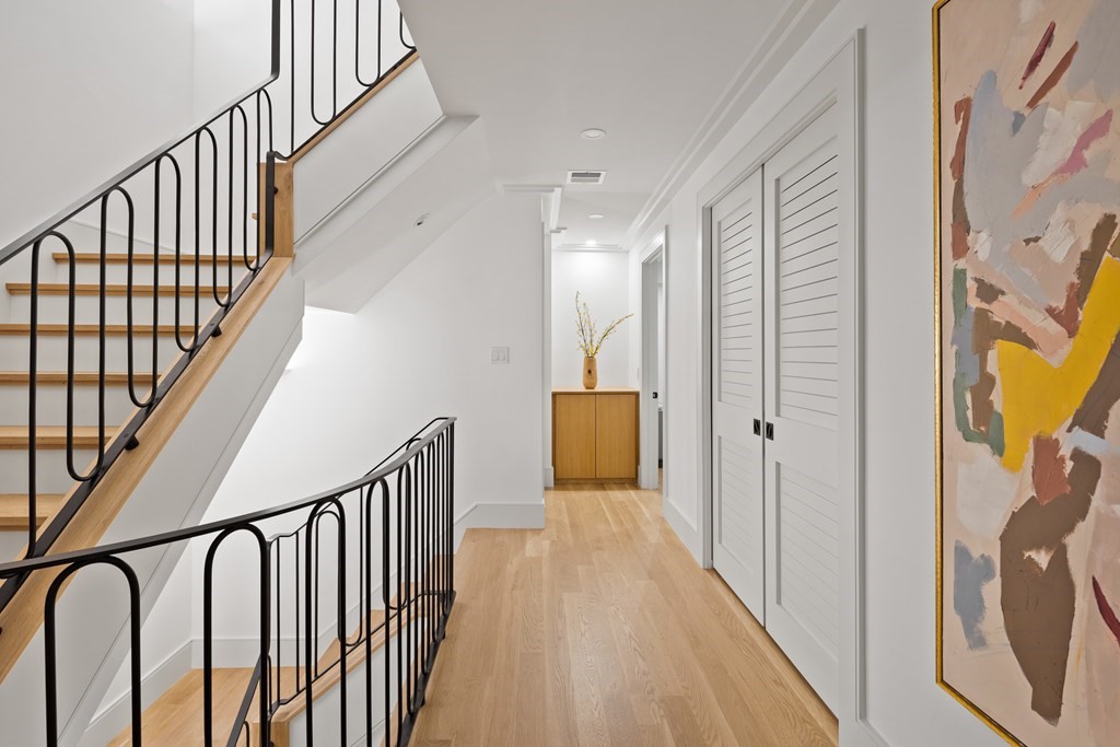 85 Willard Road Brookline, MA 02445 - Photo 12 of 29 a view of a hallway with wooden floor and staircase