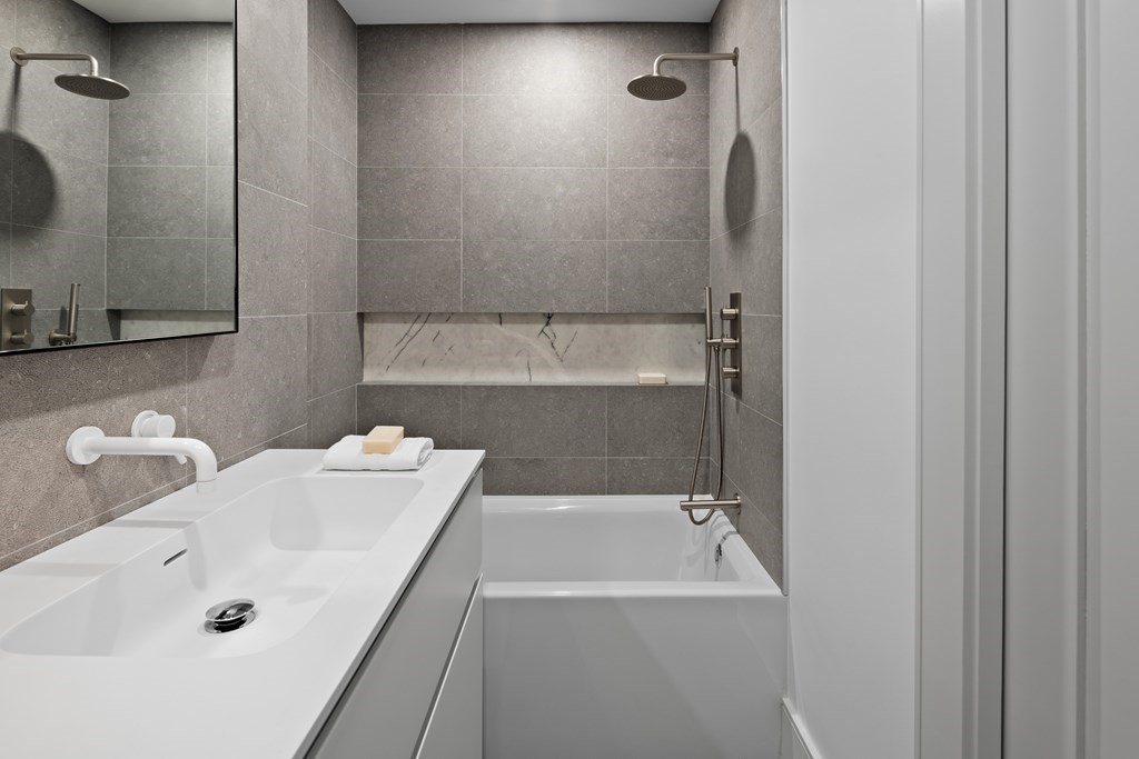 85 Willard Road Brookline, MA 02445 - Photo 14 of 29 a bathroom with a tub sink and mirror