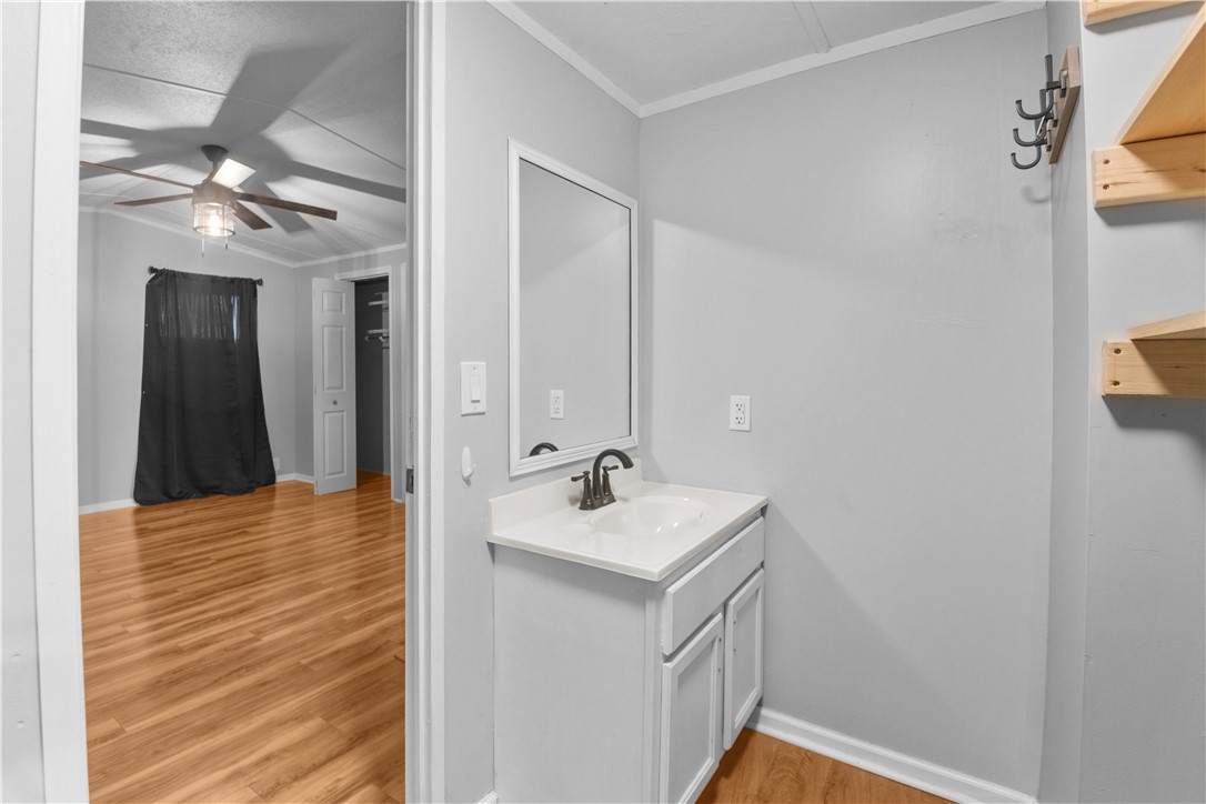 169 West Bagwell Road Liberty, SC 29657 - Photo 23 of 29 A well-appointed bathroom vanity with contemporary fixtures adjoins a bright bedroom.