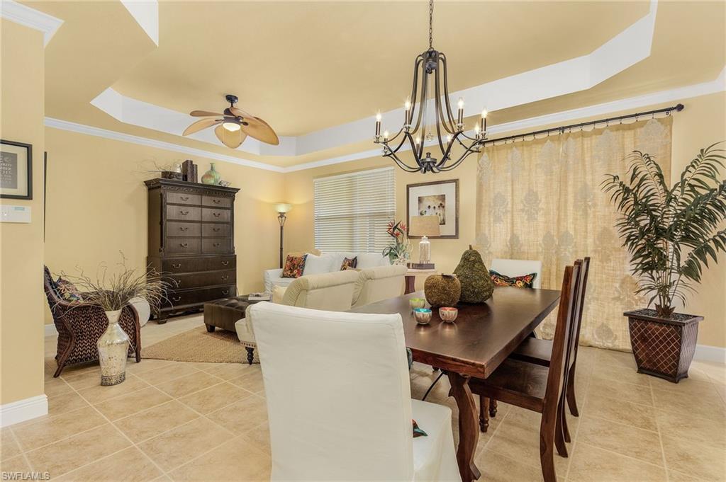 9803 Bodego Way, Unit 104 Fort Myers, FL 33908 - Photo 11 of 31 a living room with furniture a chandelier and a window