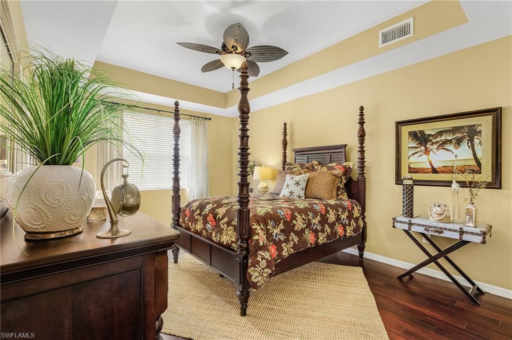 9803 Bodego Way, Unit 104 Fort Myers, FL 33908 - Photo 15 of 31 a bedroom with a bed and large windows