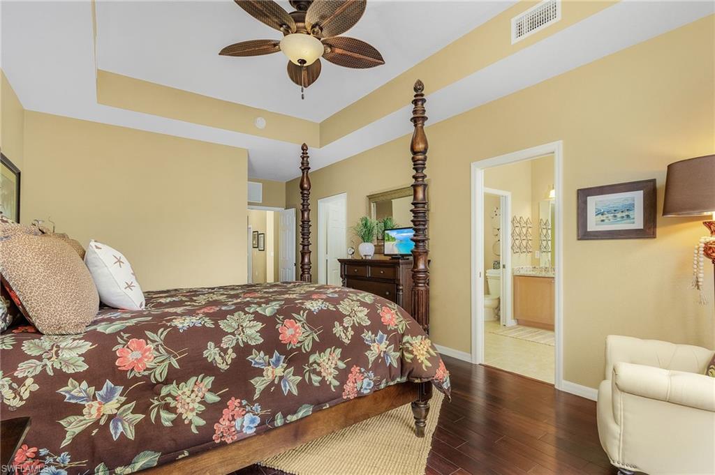 9803 Bodego Way, Unit 104 Fort Myers, FL 33908 - Photo 17 of 31 a bedroom with a bed and wooden floor