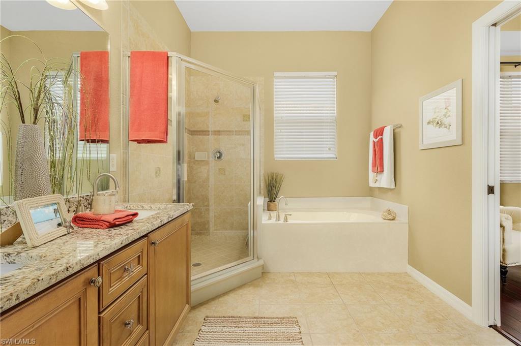 9803 Bodego Way, Unit 104 Fort Myers, FL 33908 - Photo 19 of 31 a bathroom with a granite countertop sink and a bathtub