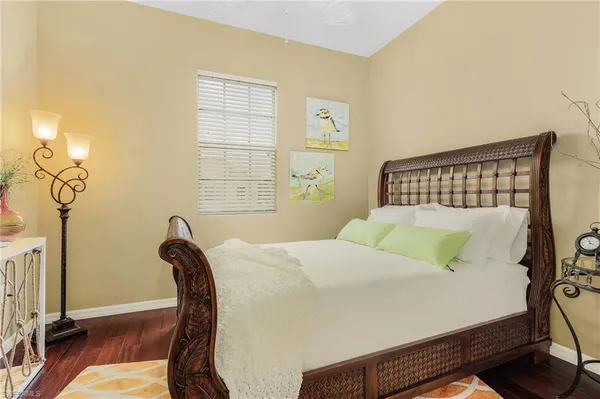 a bed sitting in a bedroom next to a window