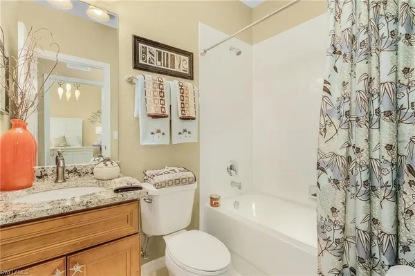 a bathroom with a sink and mirror with toilet