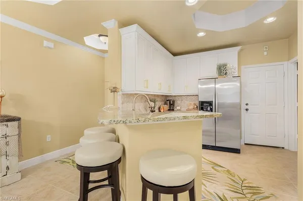 a kitchen with stainless steel appliances granite countertop a sink stove and cabinets