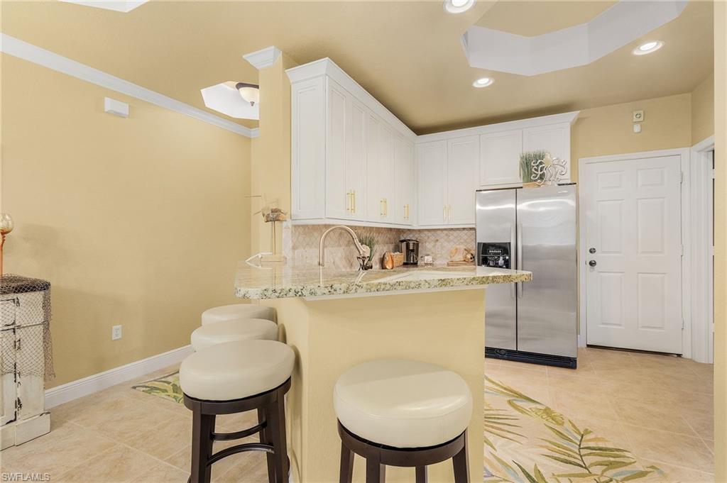 9803 Bodego Way, Unit 104 Fort Myers, FL 33908 - Photo 8 of 31 a kitchen with a sink cabinets and stainless steel appliances