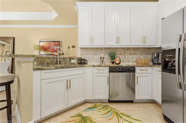 a kitchen with stainless steel appliances a stove a microwave a refrigerator and cabinets