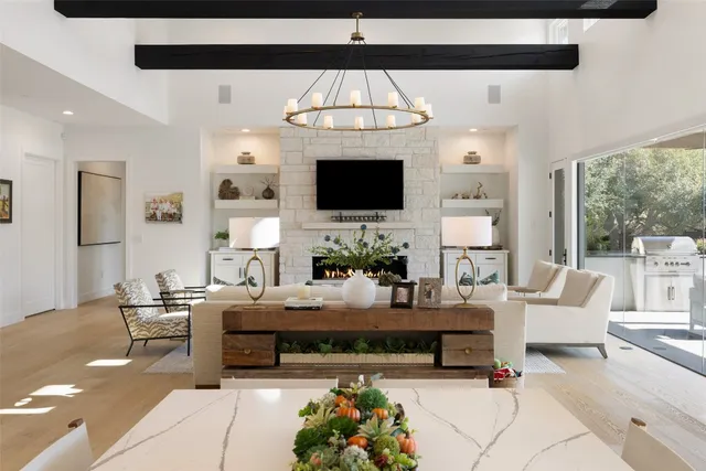 a living room with furniture a flat screen tv and a fireplace
