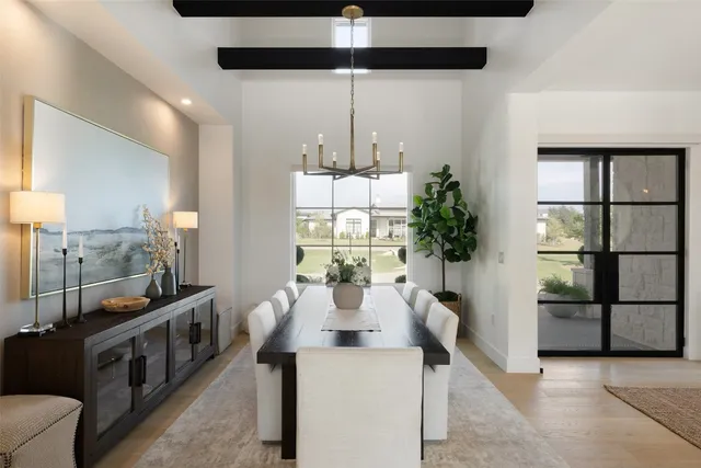 a kitchen with stainless steel appliances kitchen island granite countertop a table and chairs in it