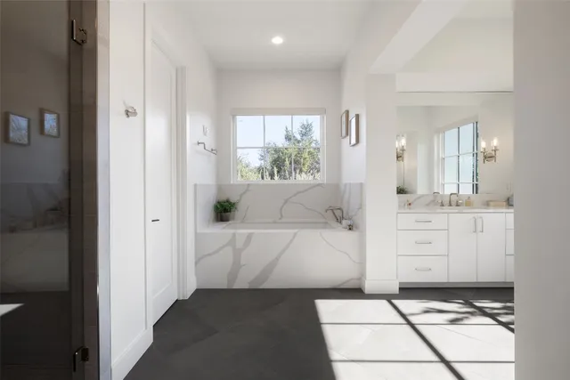 a bathroom with a double vanity sink and a window
