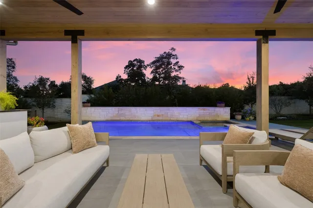 a living room with patio furniture and a floor to ceiling window