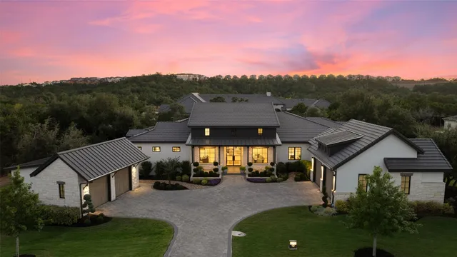 a aerial view of a house with a yard and balcony