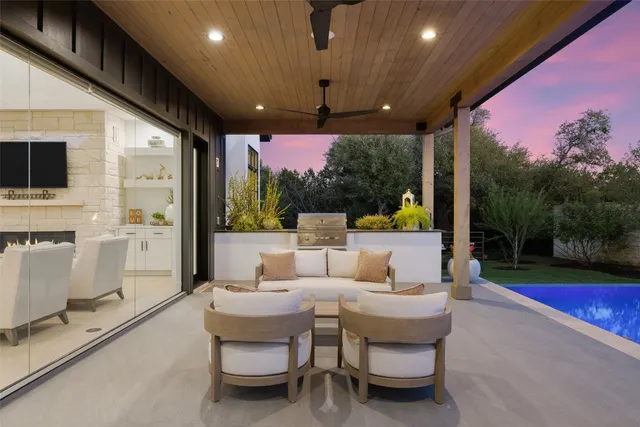 a view of a house with swimming pool and sitting area