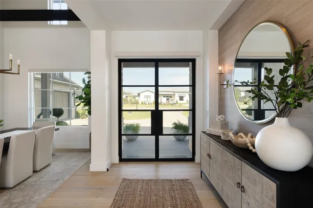 a spacious bathroom with a tub mirror and window